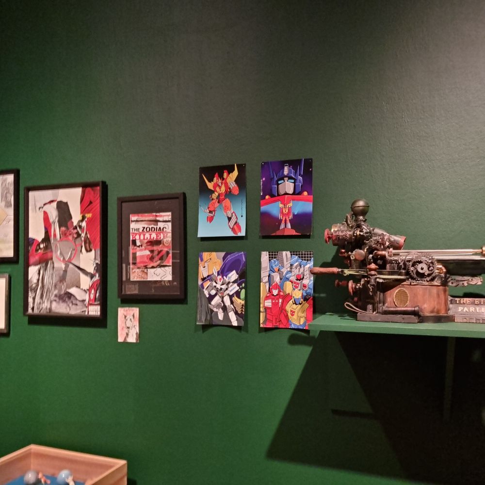 Four of my prints on a wall, surrounded by other peoples creative work