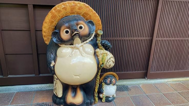 Tanuki (yokai version) statue from Japan with smaller tanuki on the side. Both statues are famous for having huge ballsack. 