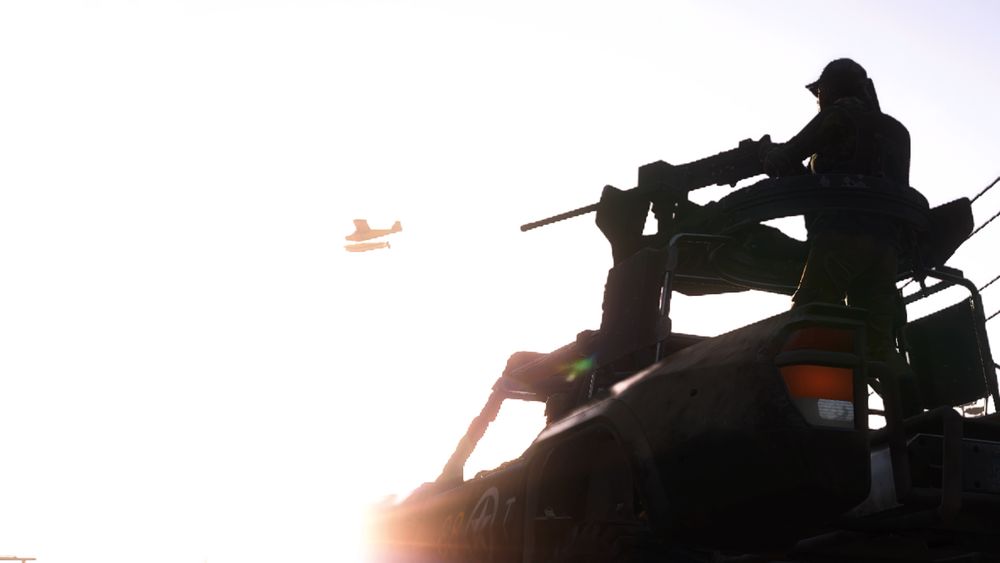 Grace on an M2 Browning as a plane flies overhead.