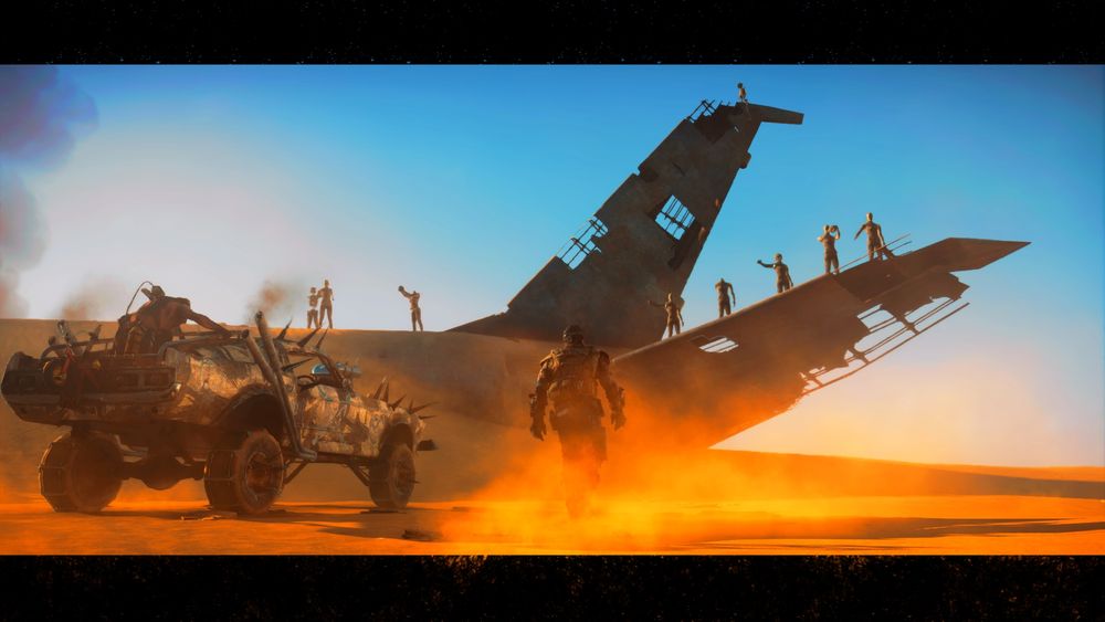 Dummies stand atop the wreckage of a plane as max approaches it. 