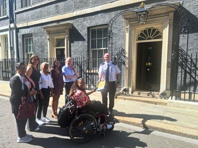 Photo of members of 6 staff and trustees from Inclusion Barnet and our campaigns team handing in our open letter to No 10 Downing Street. 