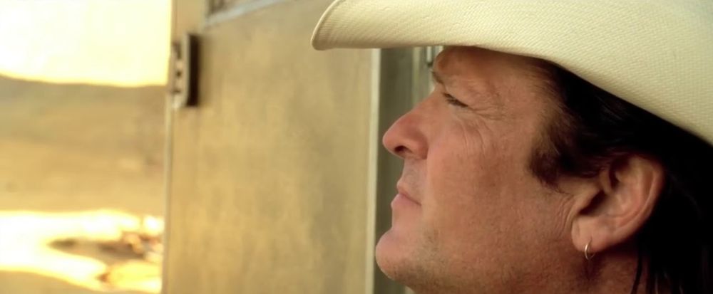 still from the scene Kill Bill where Budd looks off into the distance as he says "that woman deserves her revenge, and we deserve to die"