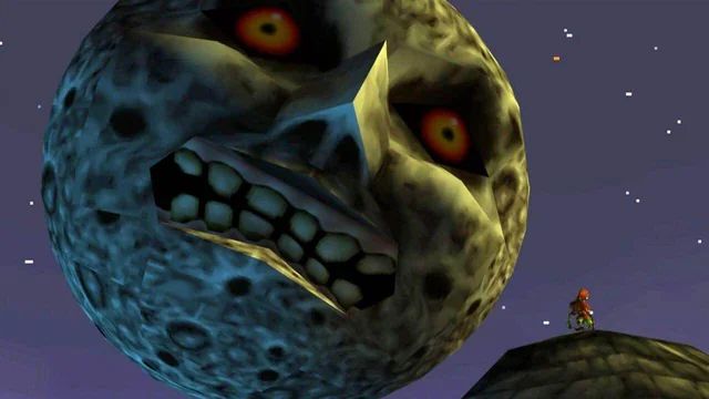 A screenshot of Majora's Mask for the N64 of Skull Kid standing atop the clock tower staring up at the moon with it's spooky face.