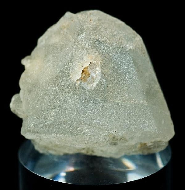 Image credit Rob Lavinsky. This is a whiteish, lumpy, imperfect, crystal that looks a lot like a badly cast rocket capsule. It has a weird orange inclusion along a facet that runs up the middle of the front. Honestly, this looks like someone tried to cast Orion in resin and had a bad day.
