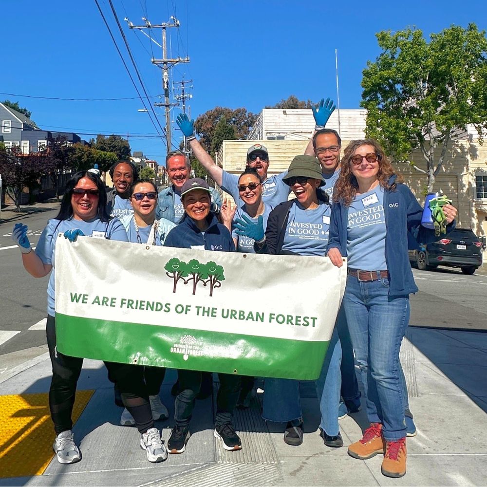 Group photo of 10 smiling people holding a sign that says, “We are Friends of the Urban Forest.”