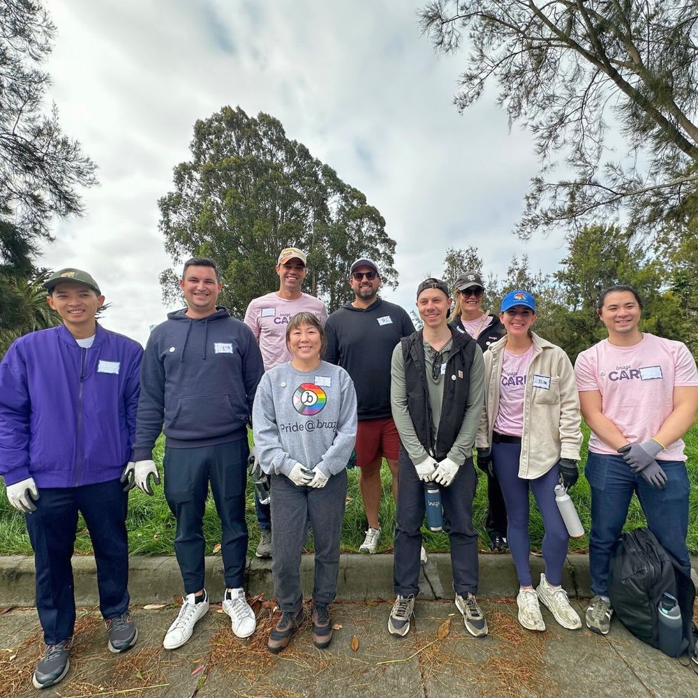 Group photo of 9 smiling tree care volunteers.