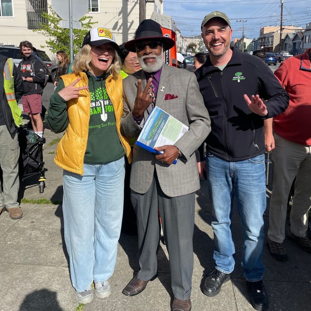 Two staff members stand with Bayview community leader, Dr. Arelious Walker.
