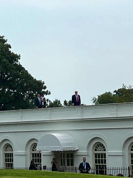 Trump standing on the white house roof for no apparent reason
