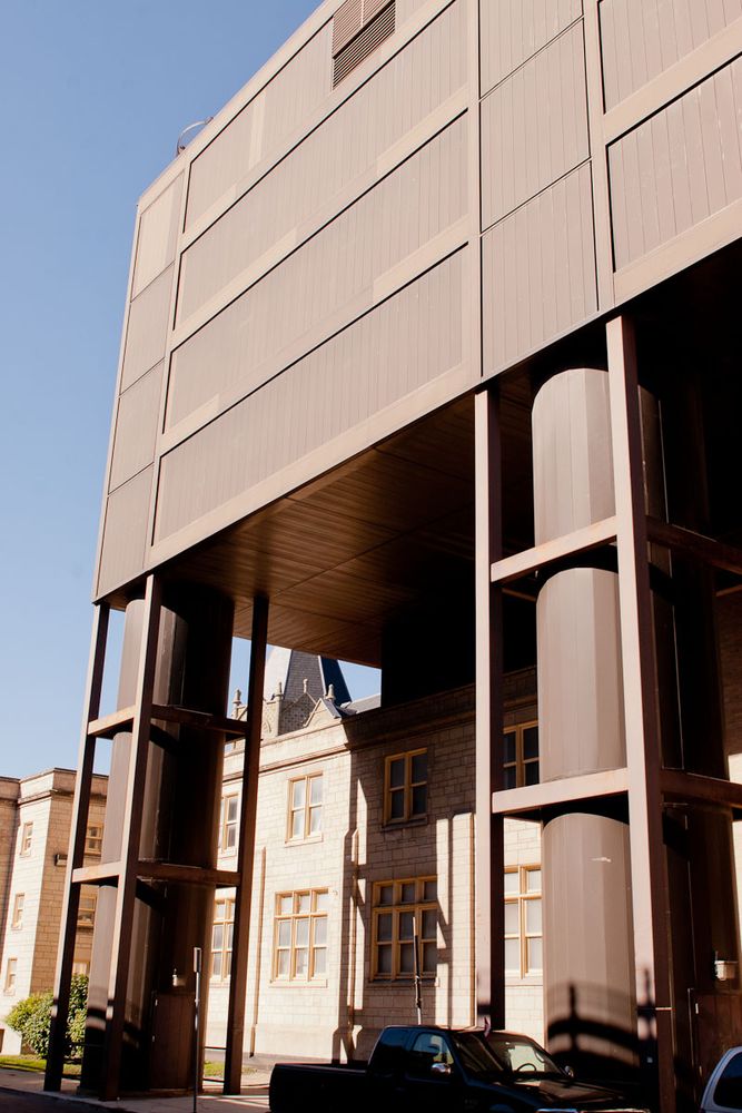 Two spiral staircases descend from the University of Winnipeg's Centennial Hall. Like stilts, they appear to support the building's entirety, which is seen here hovering over Bryce Hall. 
Photo from Winnipeg Architecture Foundation.