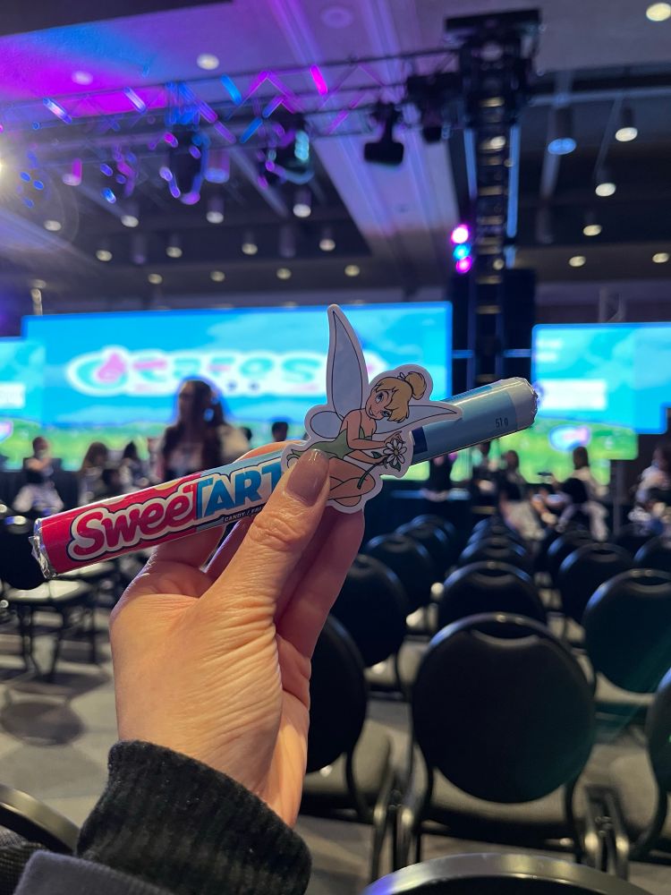 A pack of SweetTarts and cute sticker of Tinkerbell, in front of closing ceremonies at Otafest