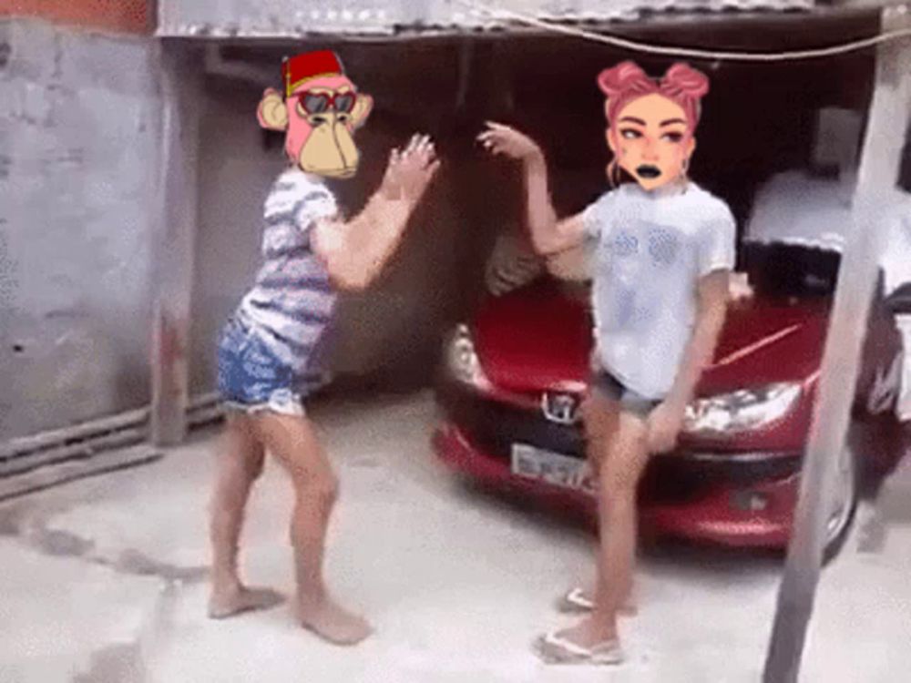 a couple of girls are dancing in front of a red car .