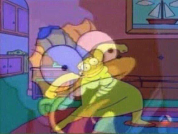 Marge Simpson dances in her living room. Superimposed is a closeup on her face, she is screaming. 