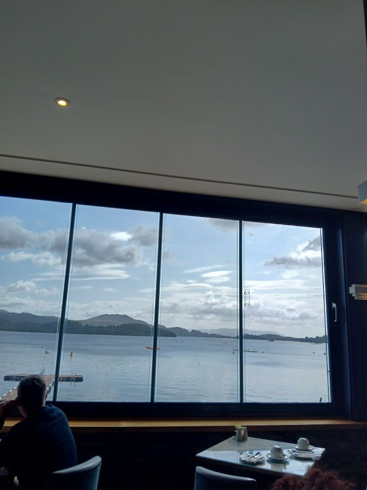 A cracking view of Loch Lomond through a large window in a posh hotel restaurant.
