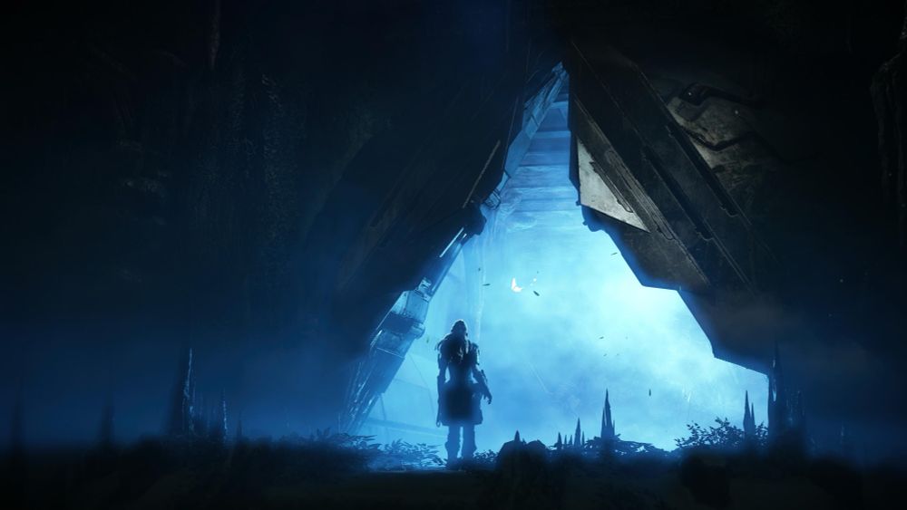 A screenshot of Horizon Zero Dawn Remastered. Protagonist Aloy is silhouetted against blue light emitting from a giant triangle-shaped doorway. 