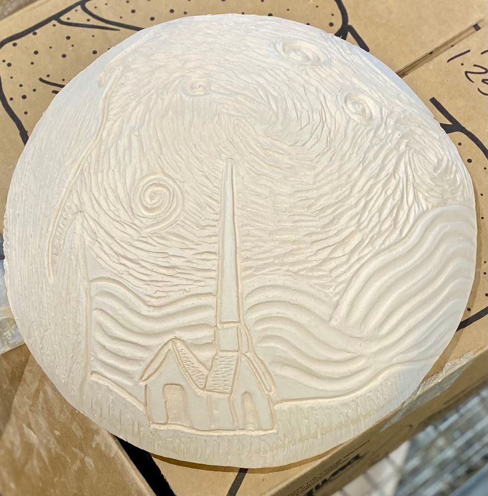Bisque-fired clay slump mold, domed circle with carved design including a building in the foreground with rolling hills, a large cypress tree, and skies with impasto style swirling winds, the moon, and stars.