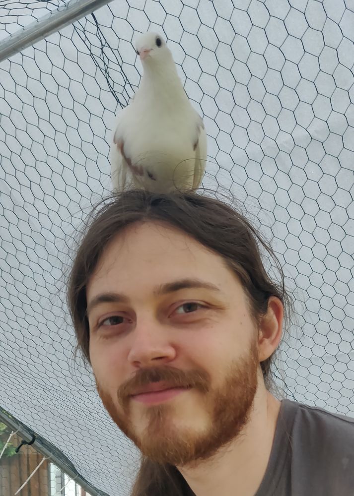 Me with my pigeon, Reina, on my head. She is cute.