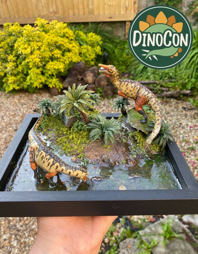 Display featuring two Dinosaurs and the DinoCon logo 