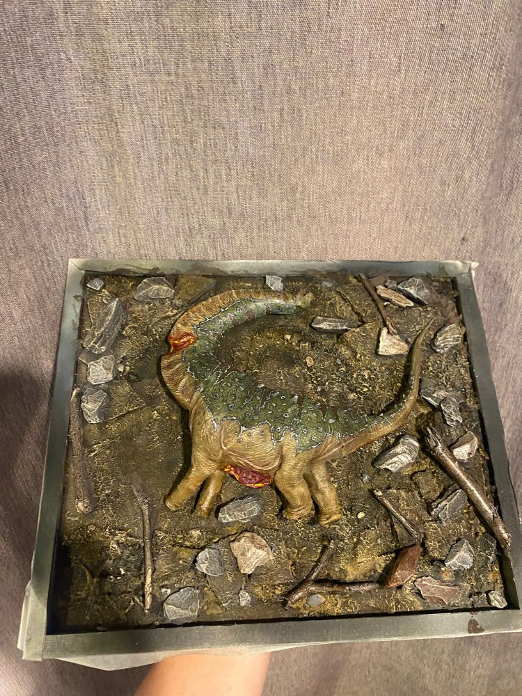 Dead Sauropod model on a rock strewn earthen display base (work in progress) 