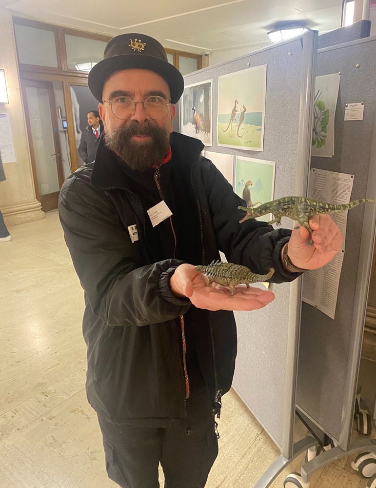 Luis Rey holding two Dinosaur Prints 