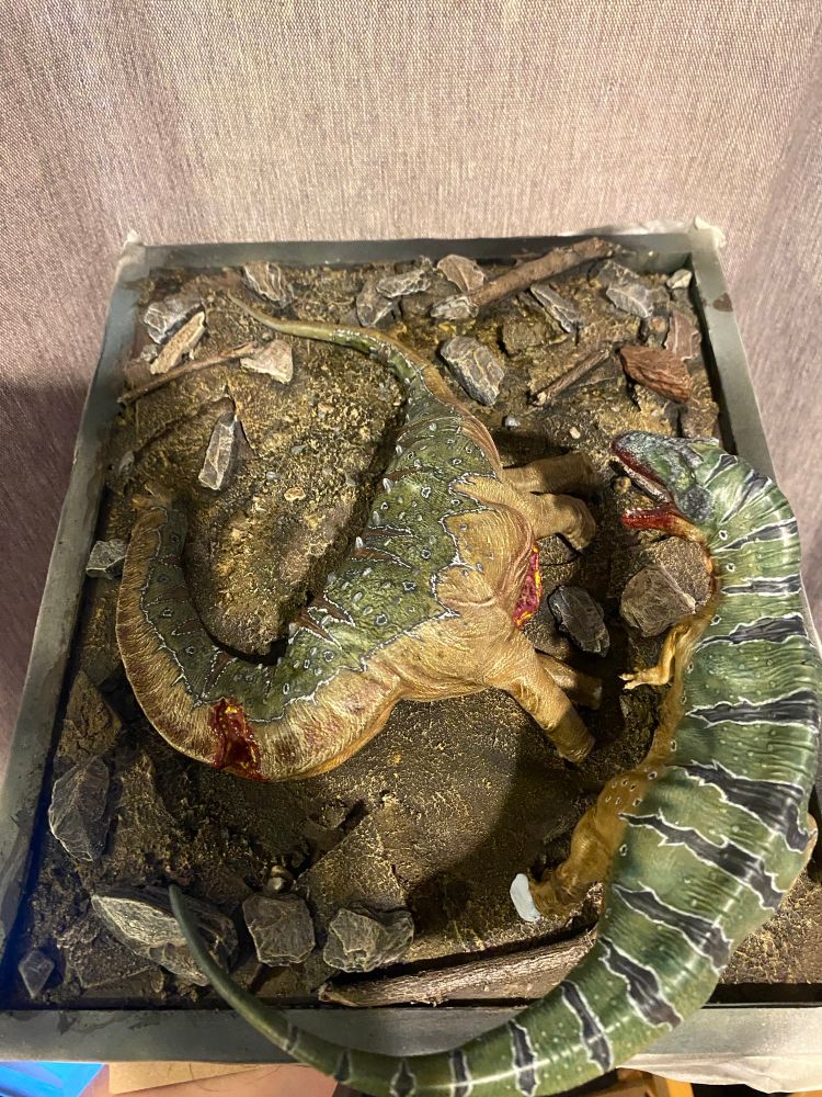 Dead Sauropod model and its killer on a rock strewn earthen display base (work in progress) 