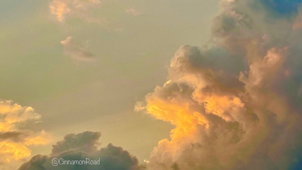 Clouds tinged with orange from the setting sun.