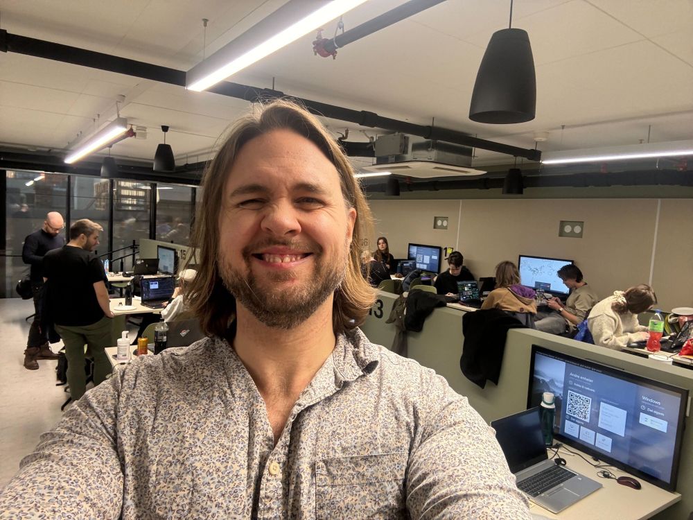 Simon, having a good time at the Oslo Global Game Jam venue. People actually working in the background
