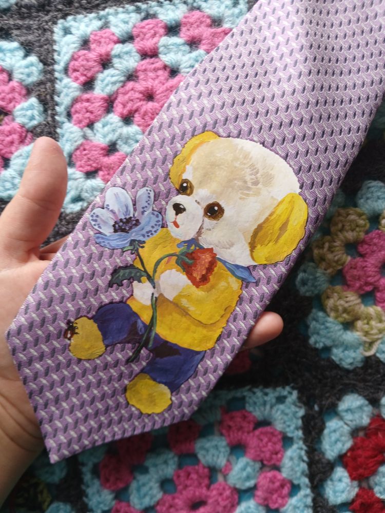 Purple tie with an image of a dog holding a flower. The dog's wearing a vintage sailor outfit