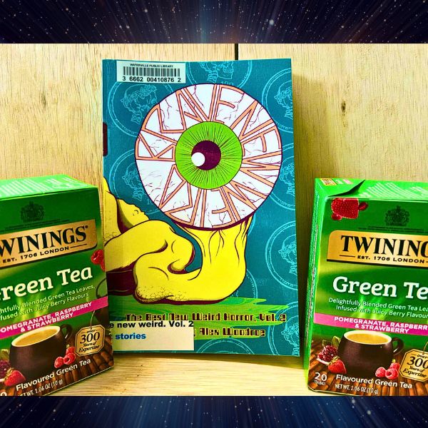 Two boxes of the described tea stand on either side of the suggested book.