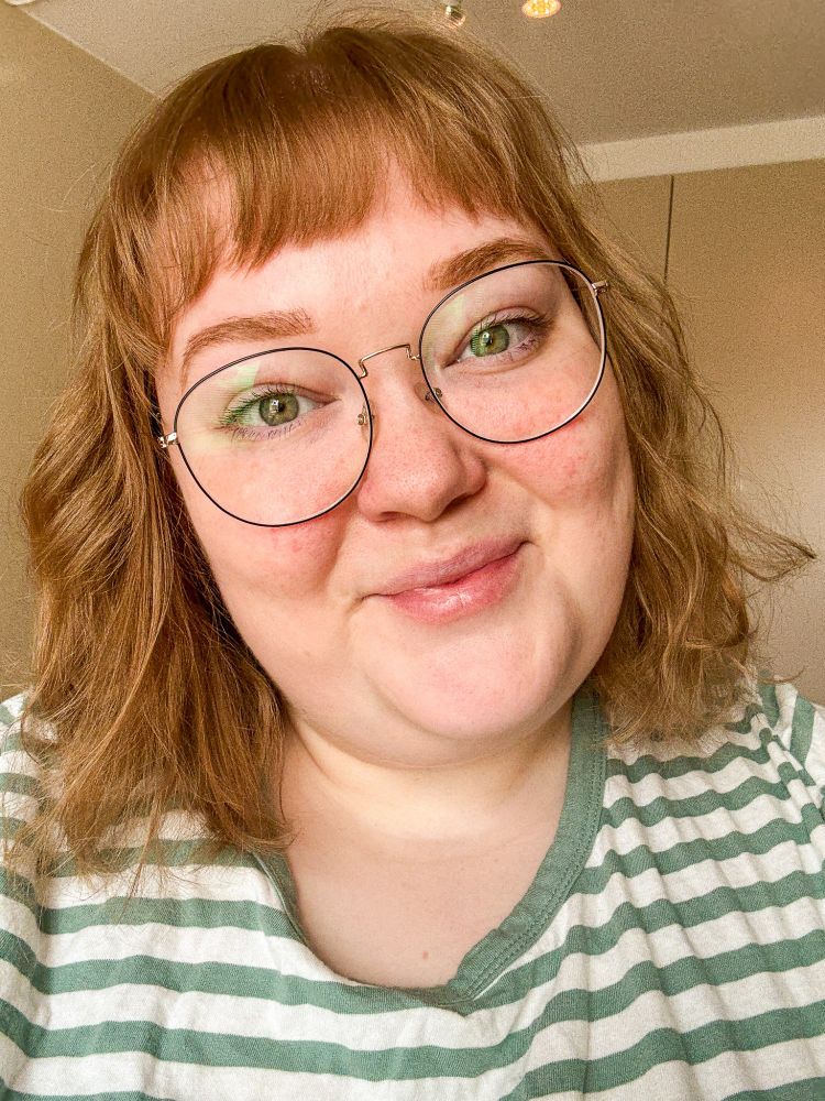 A selfie of me, a woman wearing glasses, with a bob with bangs and a striped t-shirt on.