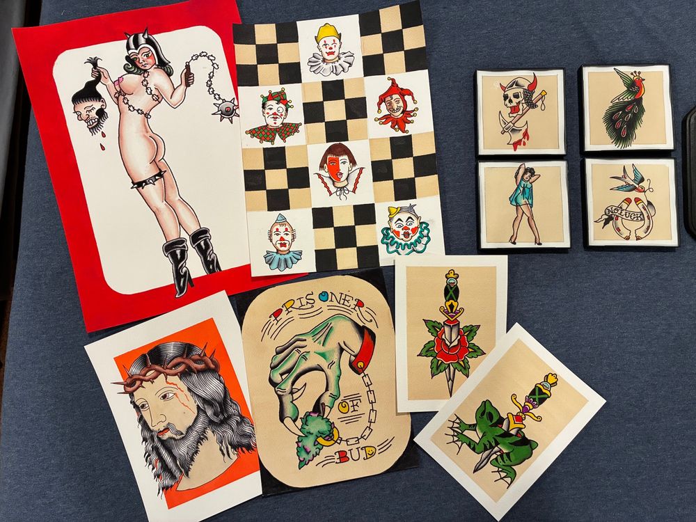 Spread of several watercolor paintings in a traditional American tattoo flash style 