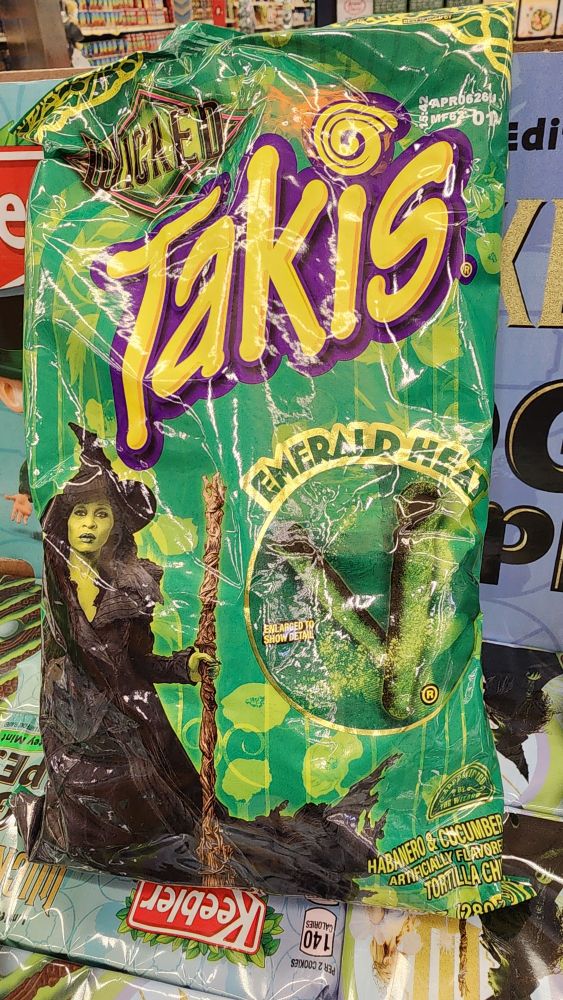A repurposed bag of Zombie Takis, made to look like merch for the second Wicked movie, with the Wicked Witch of the West right on the bag with the renamed flavor being, "Emerald Heat".