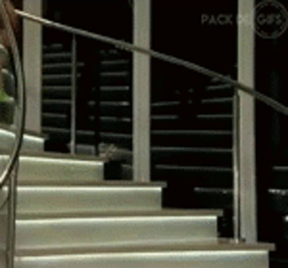 a staircase with a railing and a sign that says pack