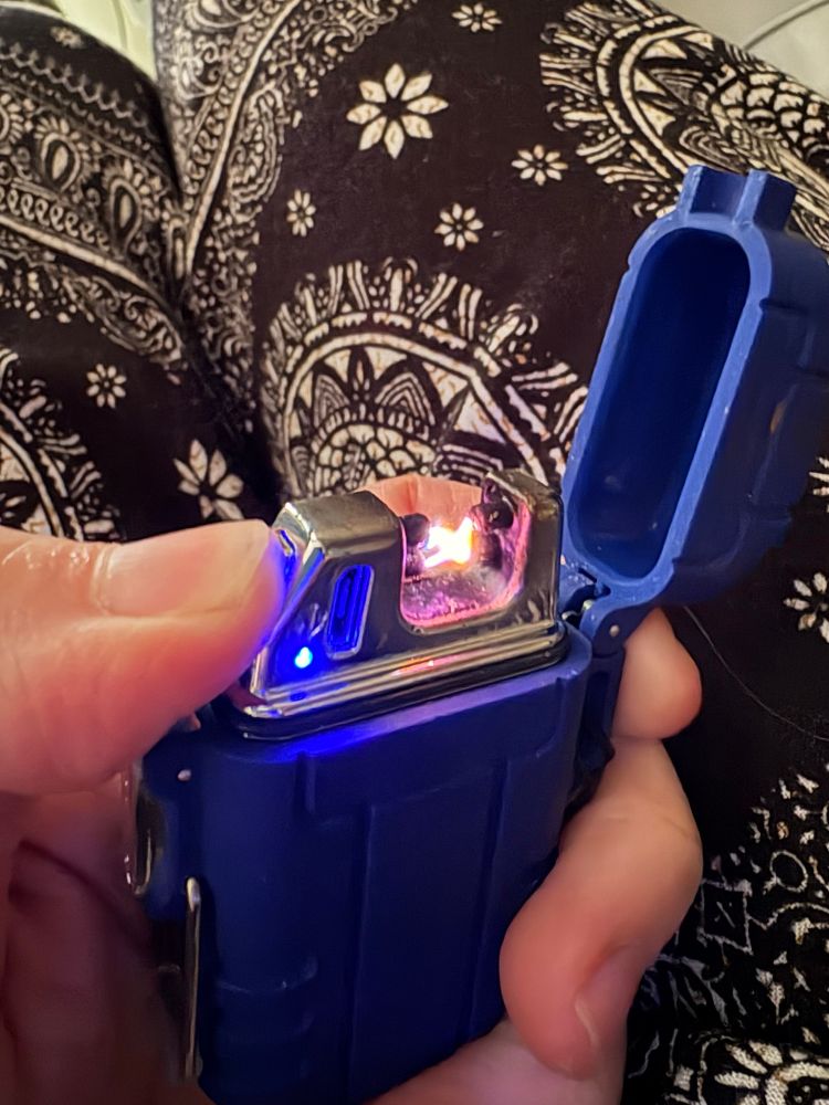 A electric looking blue lighter sparking 