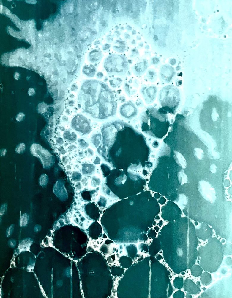 Turquoise soap with with bubbles.