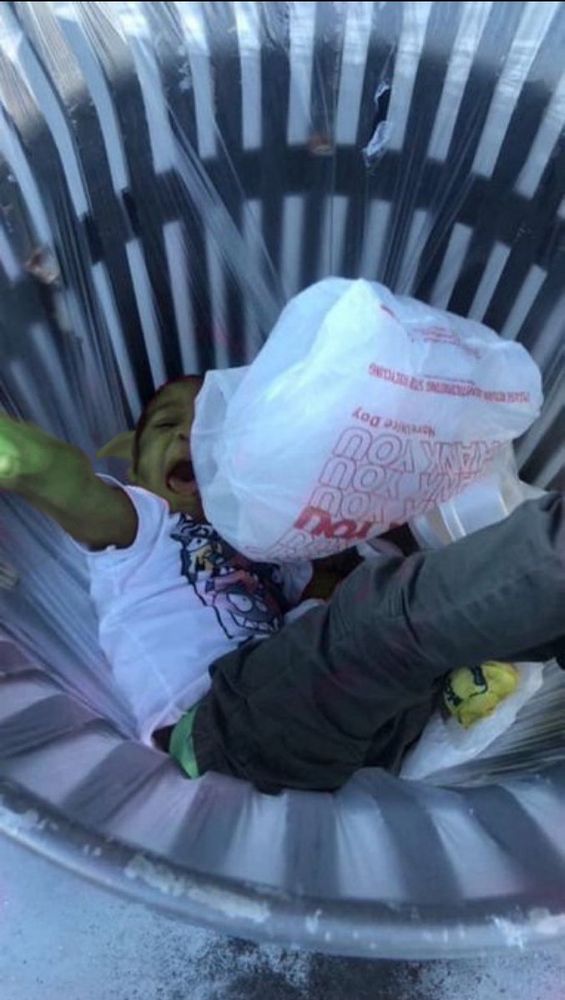 stupid green little goblin shit being thrown into the trash can of doom 