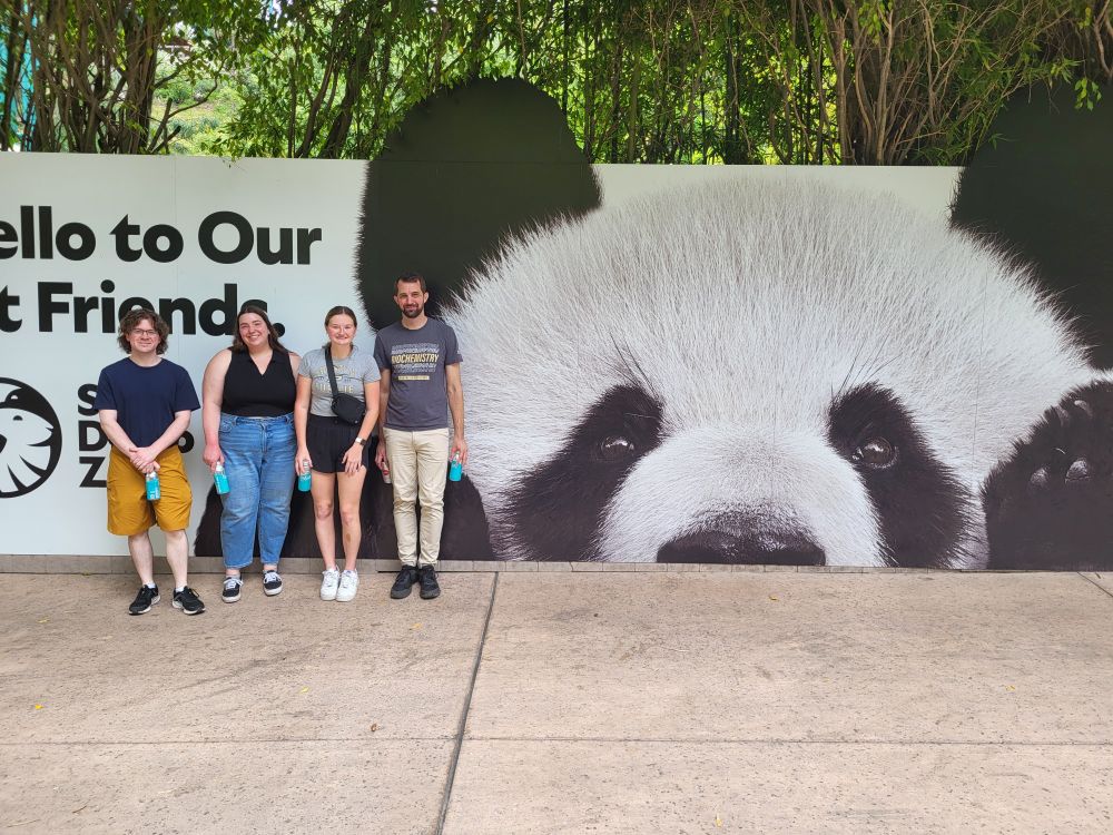 Cottrell Lab in front of a panda sign at San Diego Zoo.