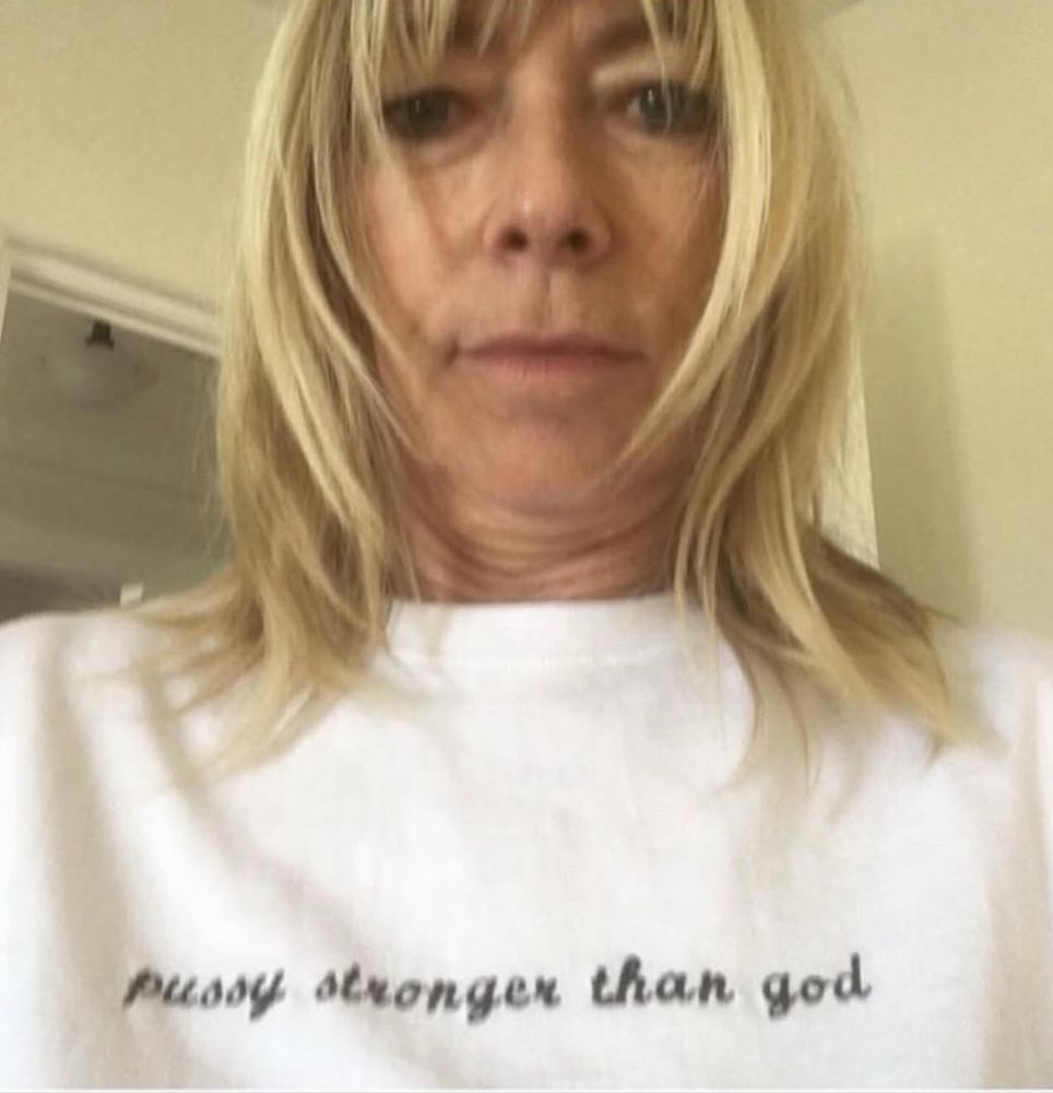 Woman with shirt that says: pussy stronger than god
