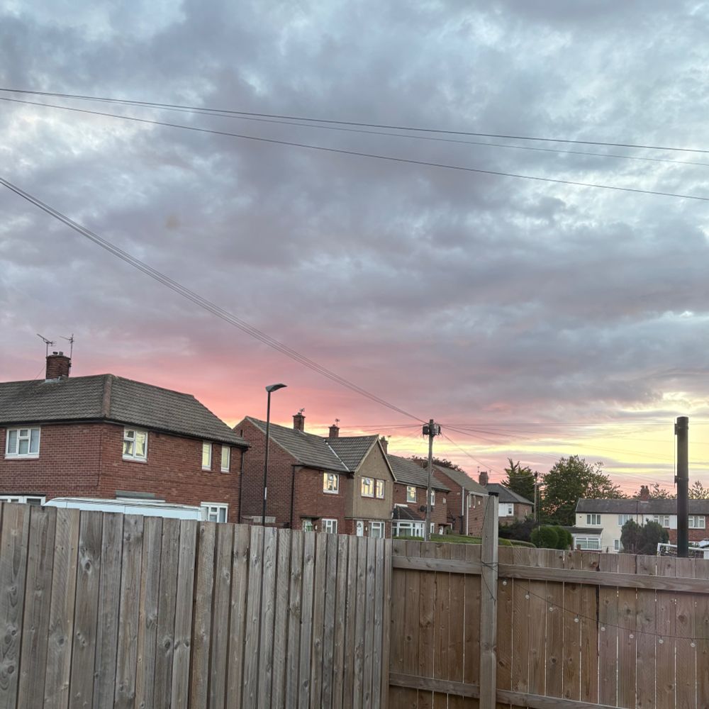 A cloudy sunrise with a flash of pink under the clouds 