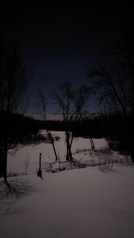 Moonlight on snow covered river