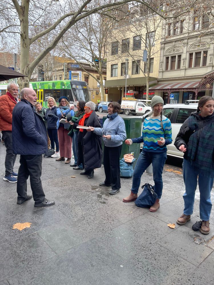 People line up to move books on a city street. 