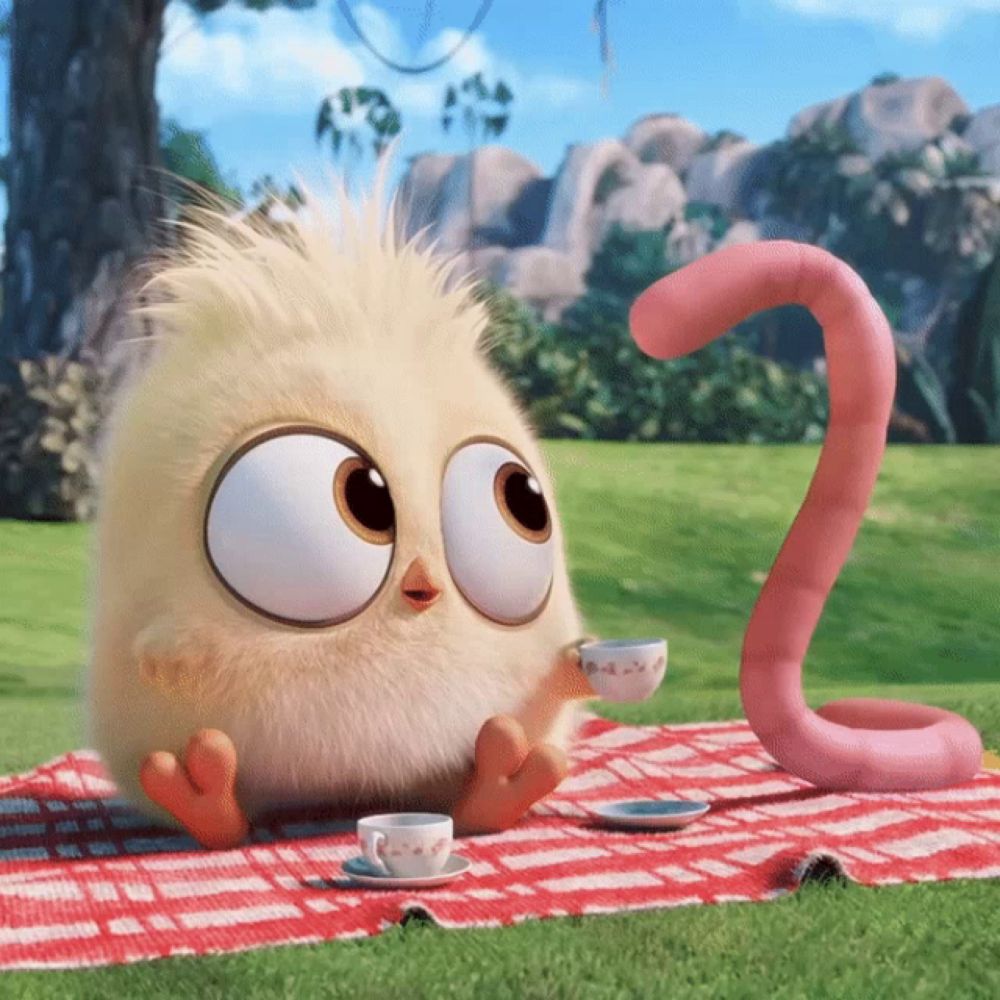 a cartoon character is sitting on a picnic blanket with a cup of tea and a pink worm