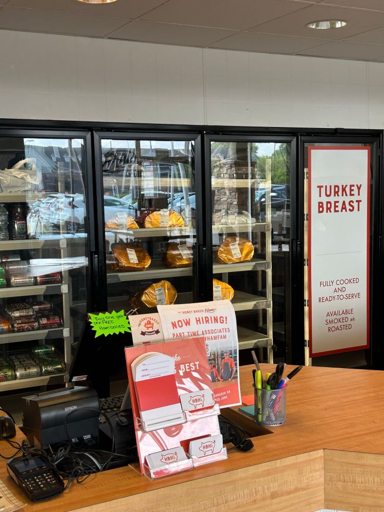 An interior shot of the Honeybaked ham counter with fridges full of hams in the background