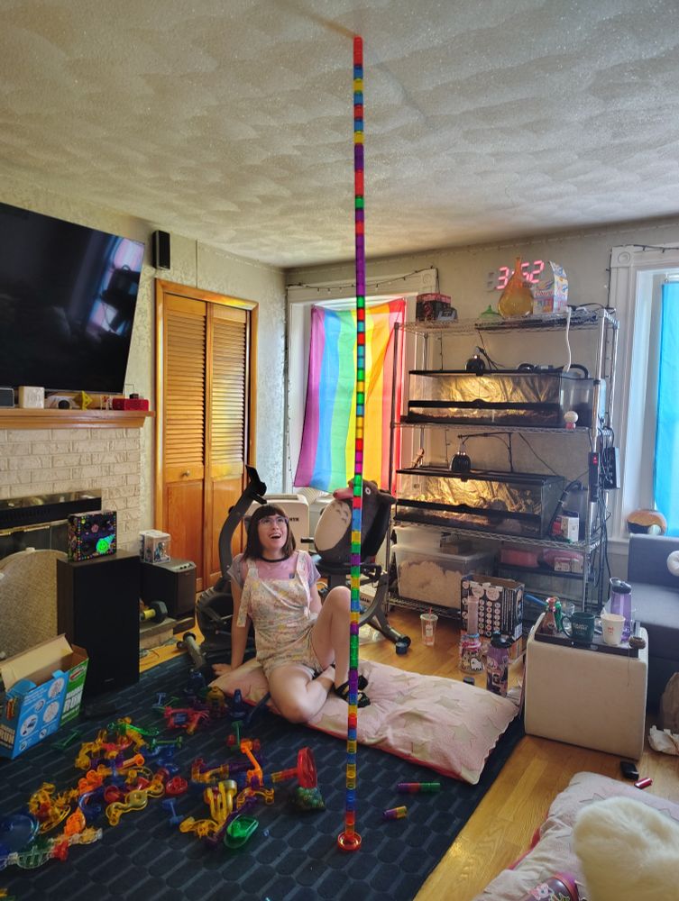 a tower of marble run segments spanning from the floor to the ceiling