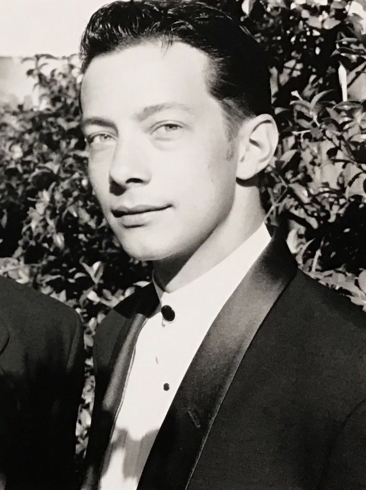 A photo of me taken shortly before my 30th birthday. It’s black and white. I’m in the bright LA sunshine, dressed up fancy (hired) for an event that a man I was seeing took me to. My hair is slicked back. I’m looking directly at the camera with a soft smile. It may be the most handsome photo taken of me - in other photos from the same period I don’t look as good. 
