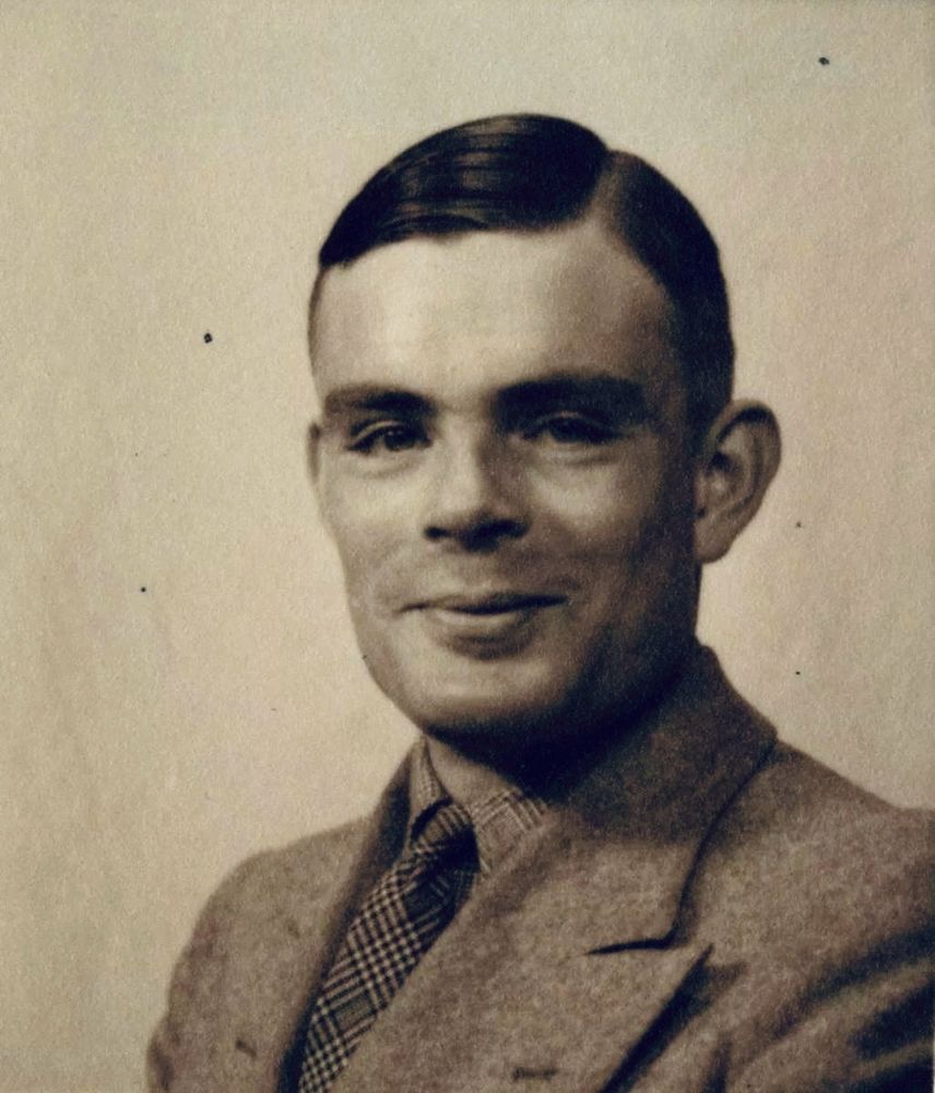 Portrait of Turing smiling rather frutily. 