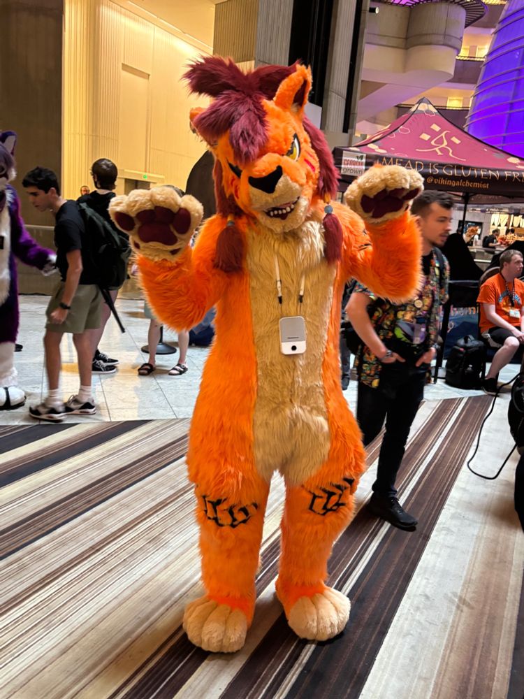 Red XIII fursuiter at Furry Weekend Atlanta 2025.