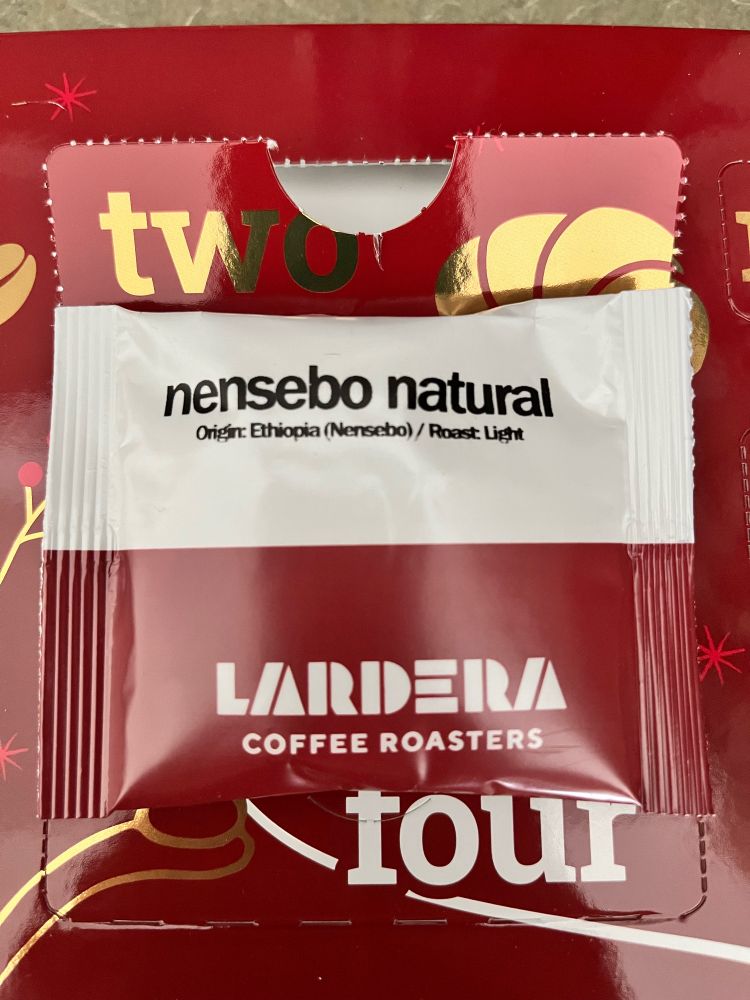 Packet of coffee. Packet reads "Nensebo Natural. Origin: Ethiopia (Nensebo) / Roast Light" with the Lardera Coffee Roasters logo below. The packet is below the word Two.