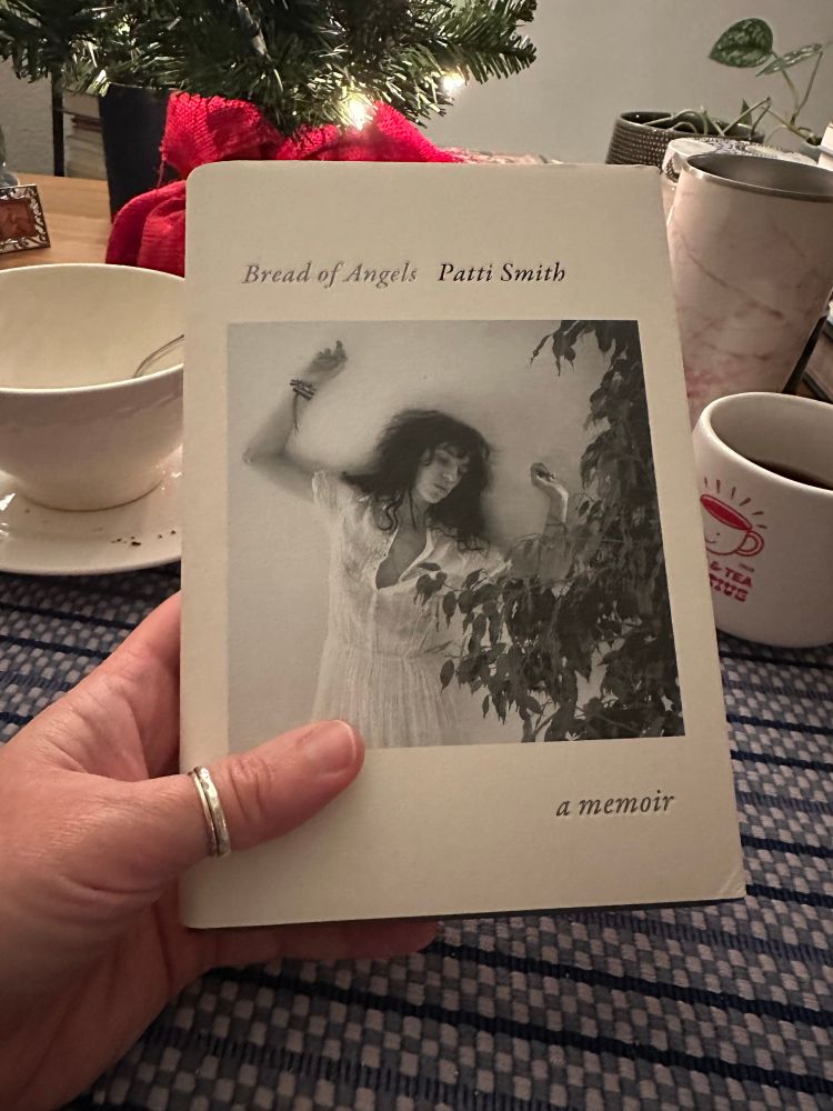 Picture of Patti Smith’s latest book, Bread of Angels, with coffee cup and cereal bowl.