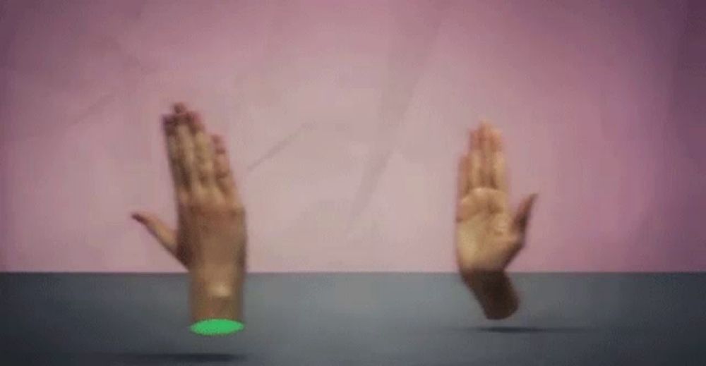 a pair of hands are floating in the air on a pink background .