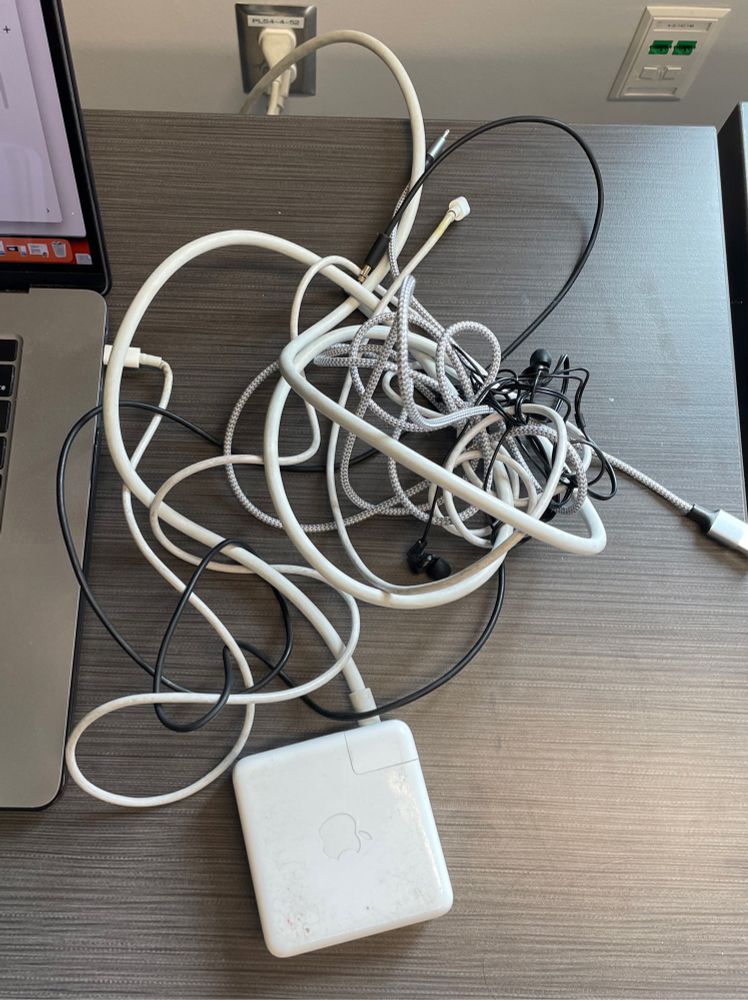 Large tangle of computer cables and headphones